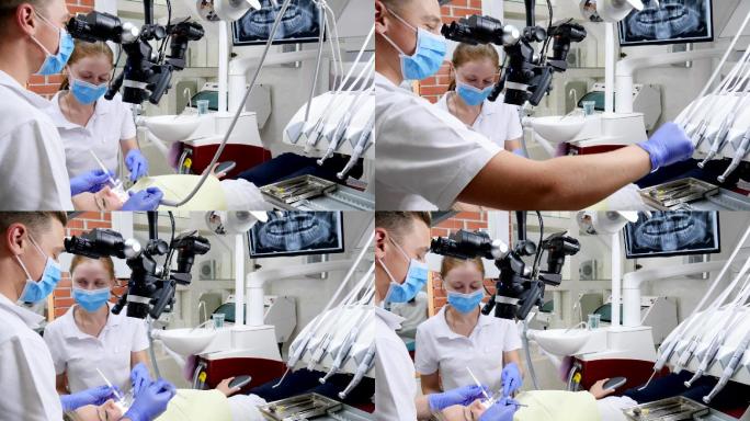 医务人员在医院使用牙科显微镜治疗病人的牙