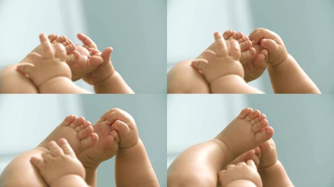婴儿手与婴儿脚近距离玩耍
