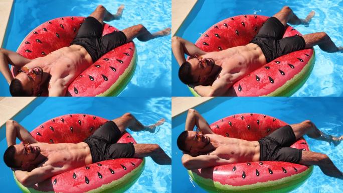 男士在漂浮的西瓜水环上放松。