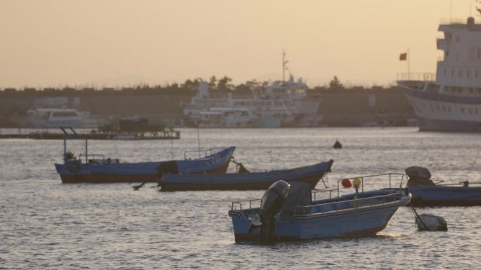 海边夕阳下停靠的船只渔船