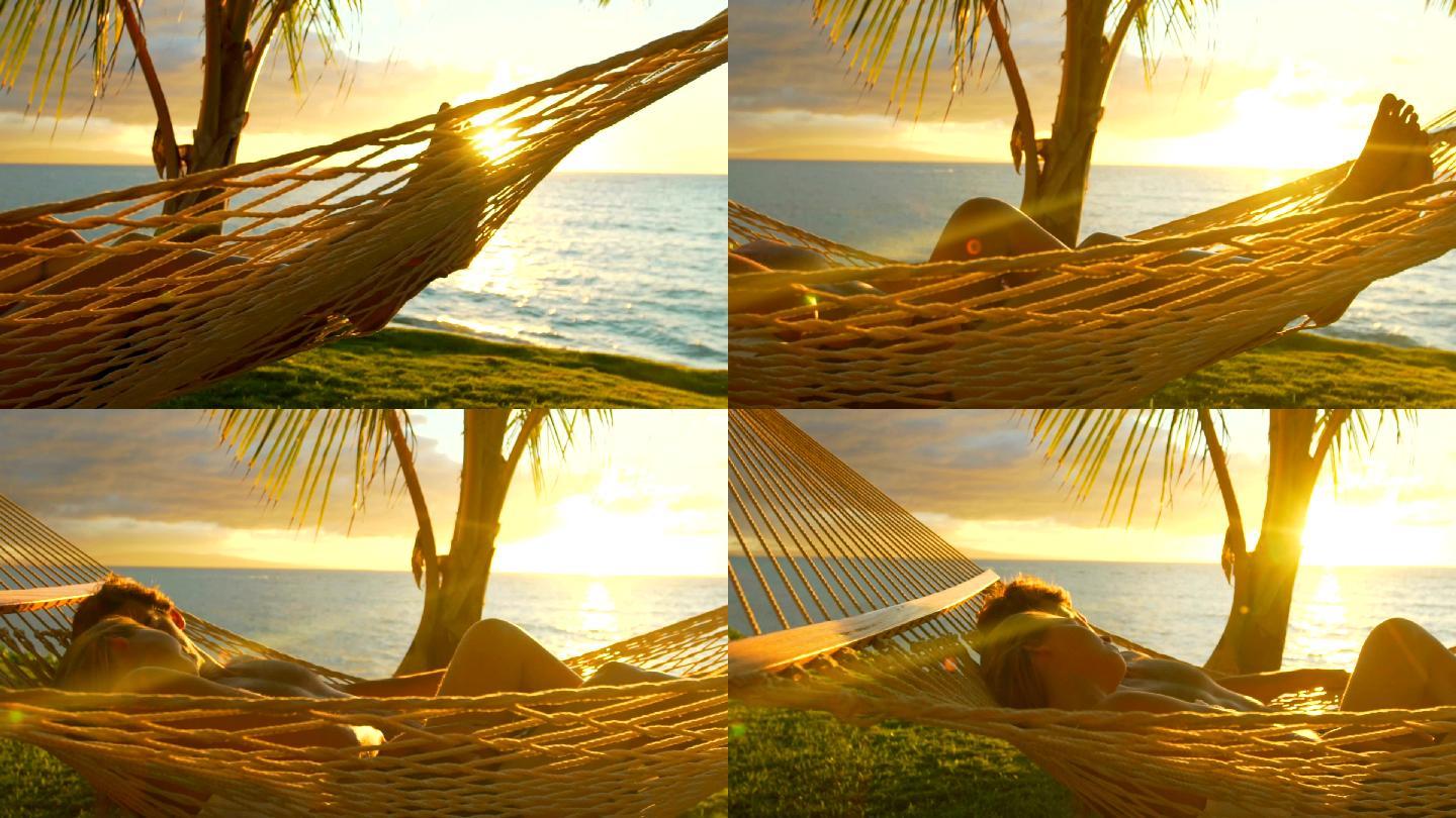日落时分，一对浪漫的情侣在热带吊床上放松