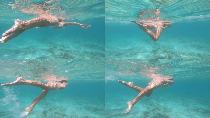 在水下游泳的女人。