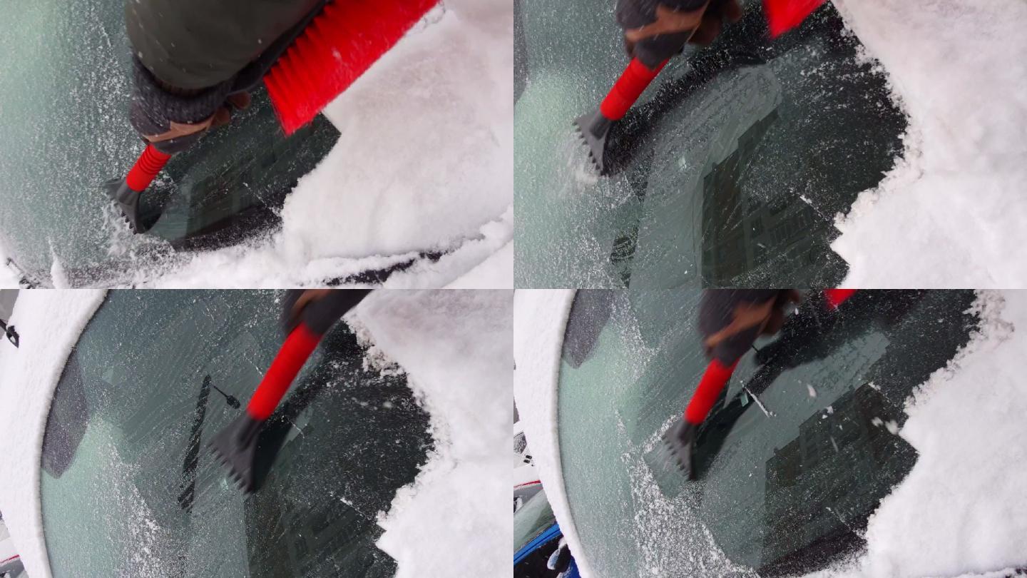 用刮刀清理汽车挡风玻璃上的冰