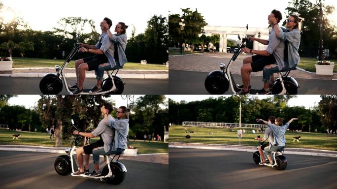 年轻夫妇在街上骑着一辆电子微型自行车