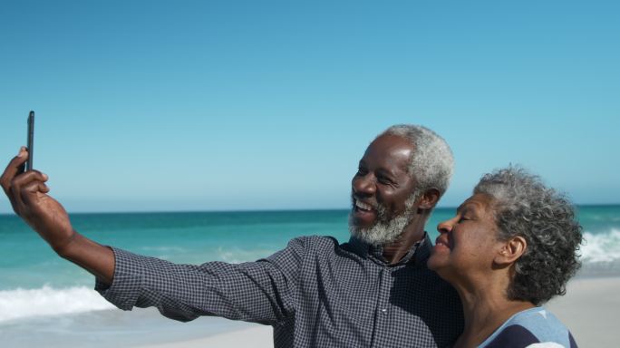 老年夫妇在海滩拍照