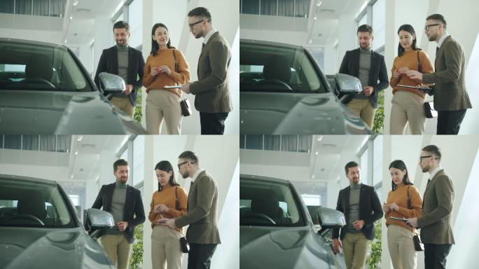 夫妇和汽车经销商谈论汽车