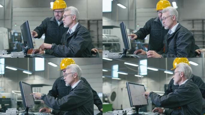 两名工程师正在工厂的台式计算机上工作。