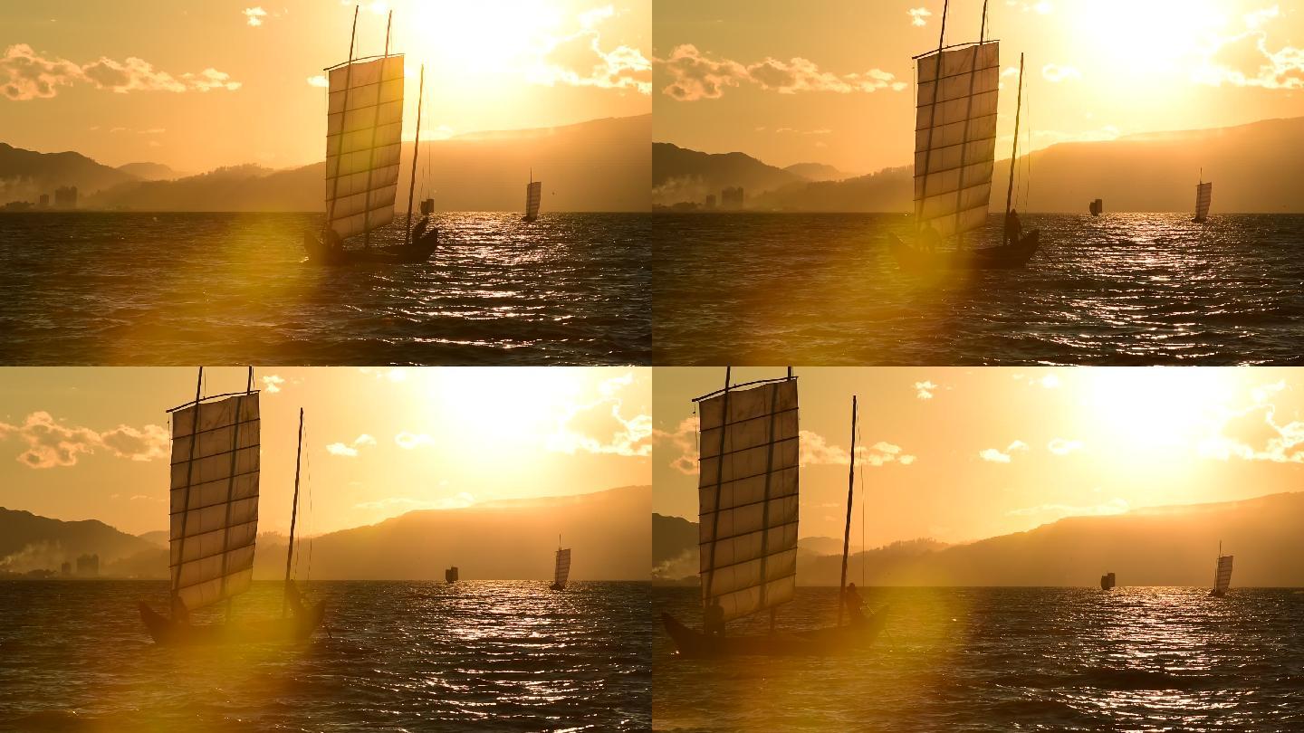 夕阳时湖泊中的帆船