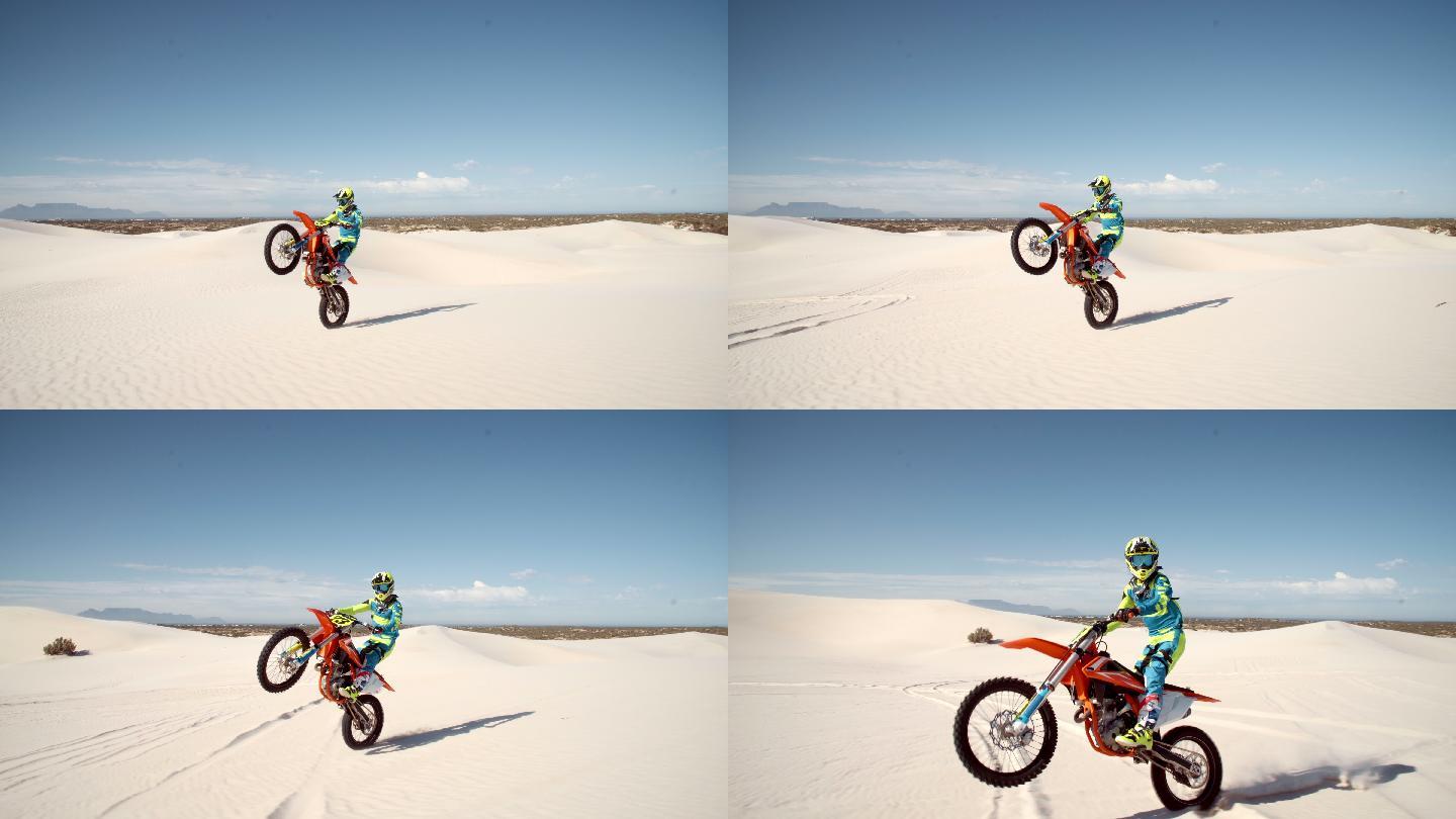 在沙丘上做特技的专业土制摩托车手。