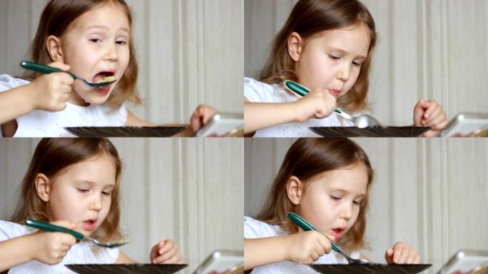孩子用勺子吃饭可爱女孩吃饭