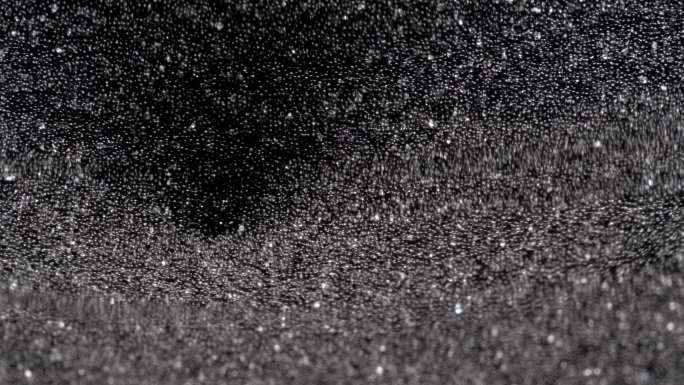 沙子穿过沙漏。黑色流沙黑洞时光流逝动态空