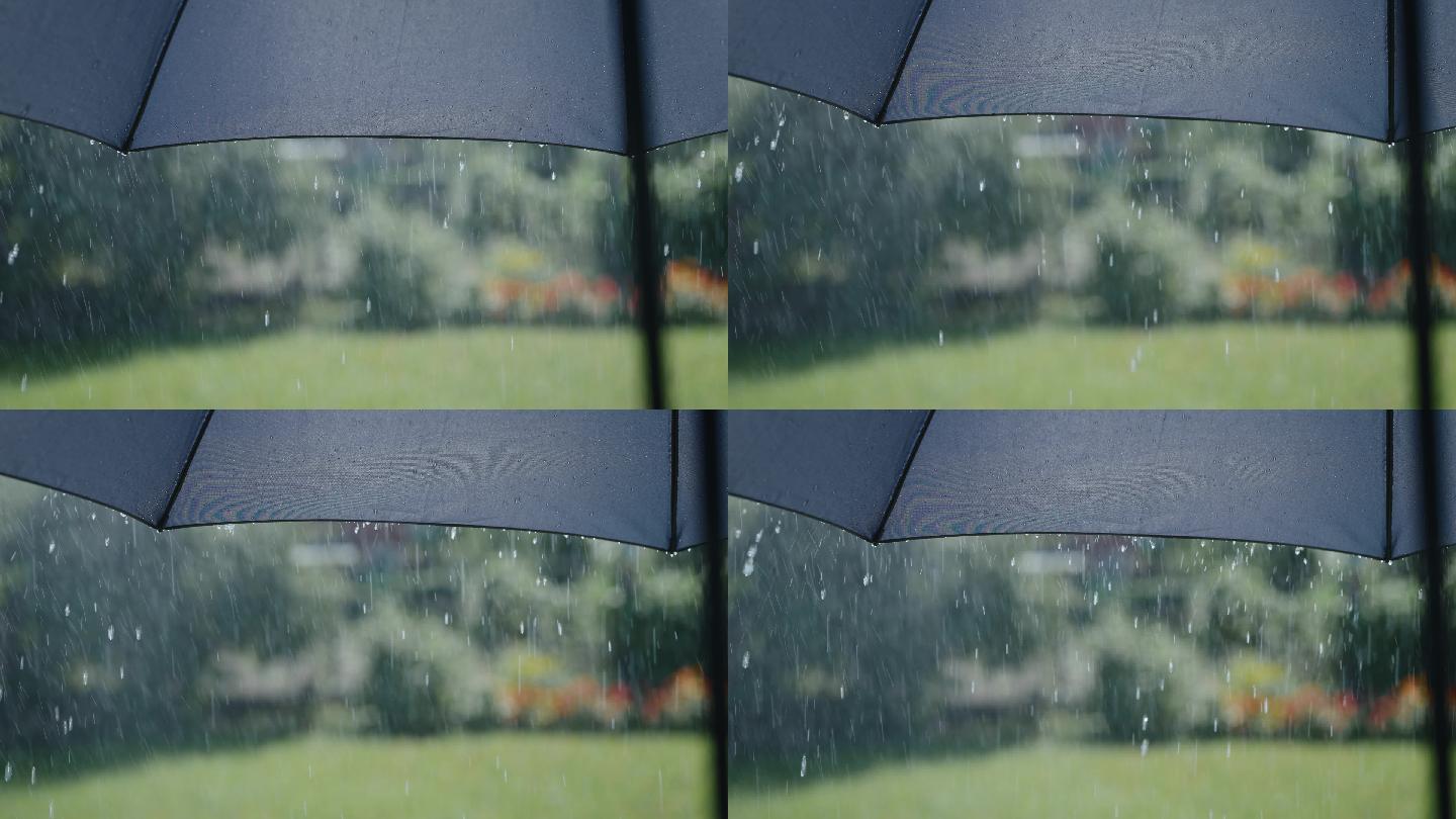 下雨时水滴从灰色伞的表面流下来