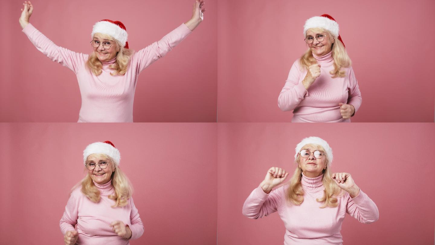 快乐活泼的女士，戴着圣诞帽跳舞