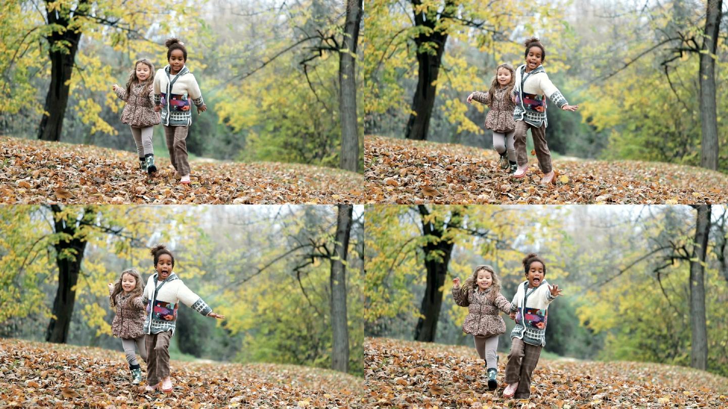 两个女孩手牵着手在公园里跑步