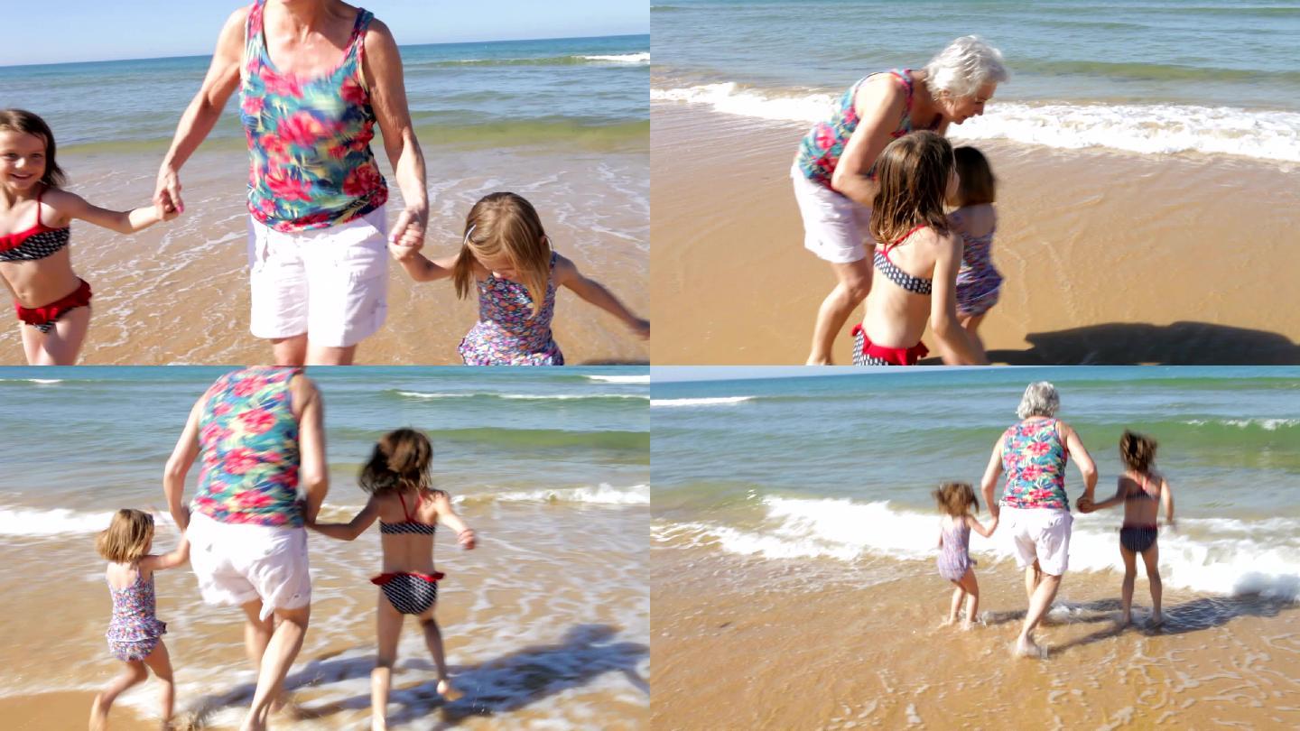 奶奶和孙子孙女在海浪中嬉戏