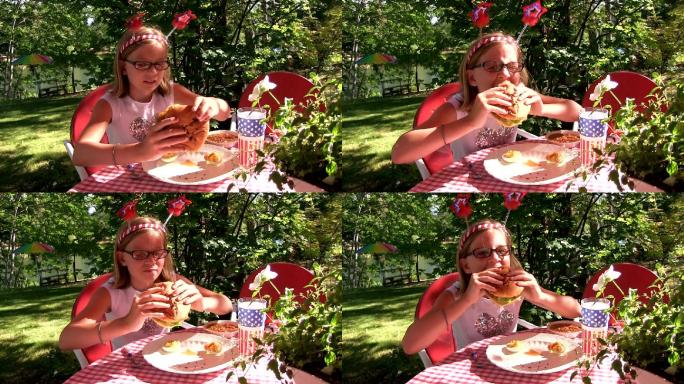 一个阳光明媚的日子，小女孩在外面吃汉堡包