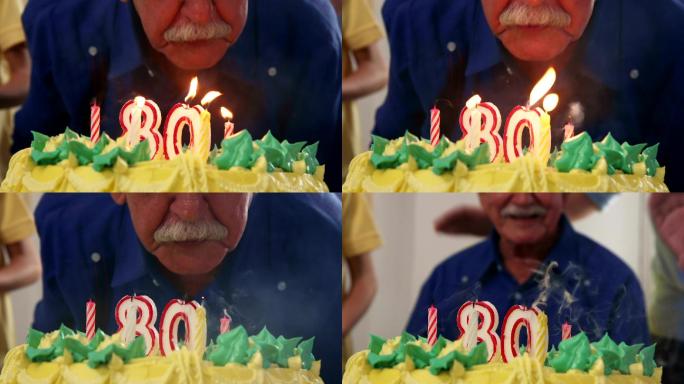 老人在生日聚会上吹蜡烛