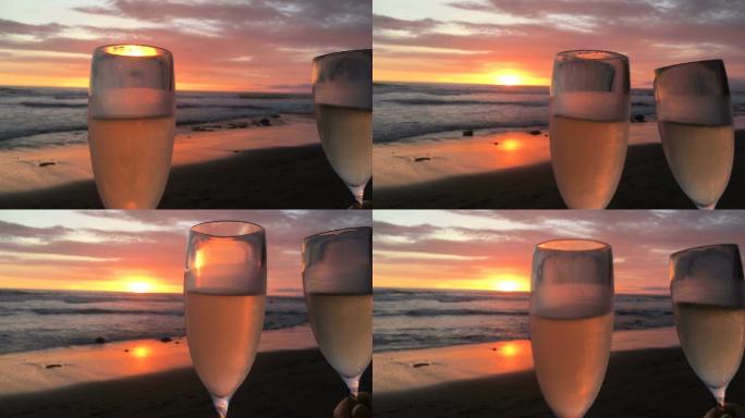海滩上壮丽的夕阳下的两杯香槟酒