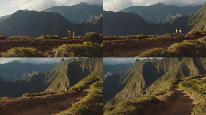 日落时两名跑步者探索山脊的鸟瞰图