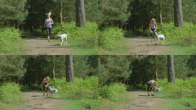 一个女人和狗狗在森林里奔跑