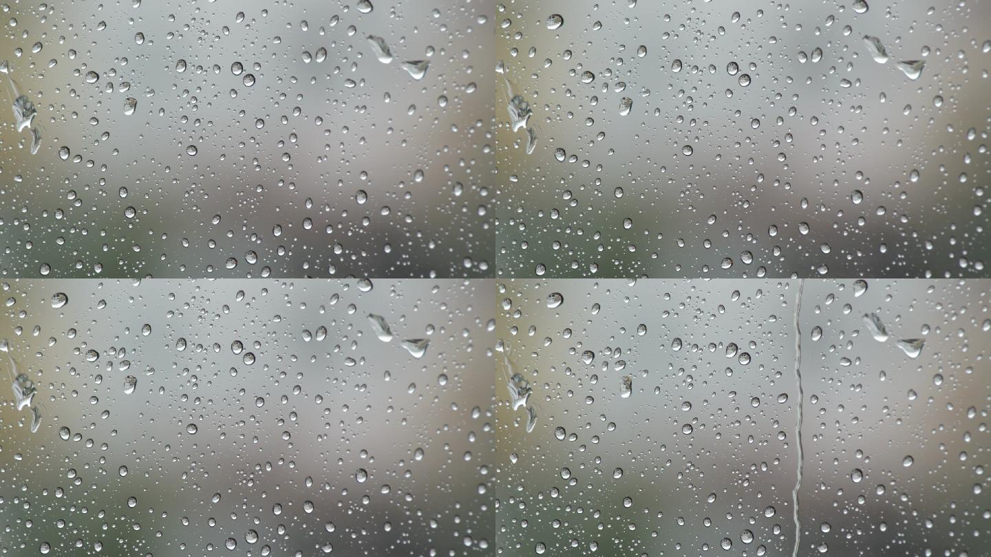雨天，雨点滑落在窗户的玻璃上