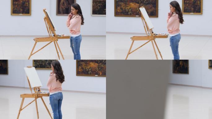 站在画布前的艺术家女孩。