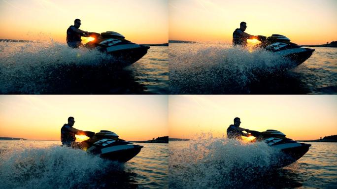 日落时，一名男子正在沿海岸线乘坐摩托艇