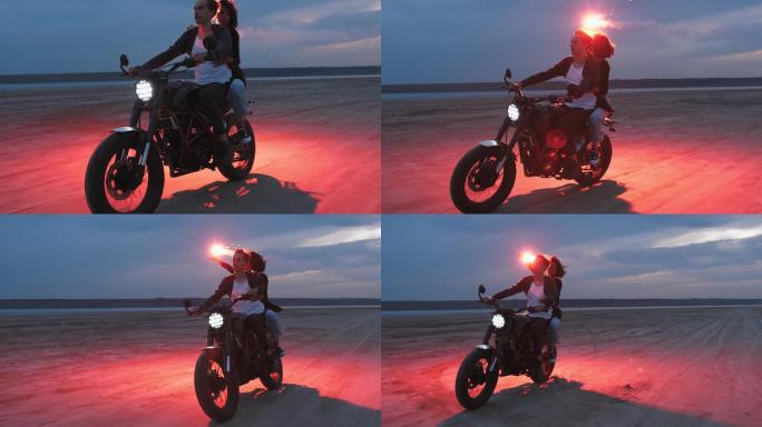 骑摩托车的情侣情侣在海边骑摩托浪漫玩烟花