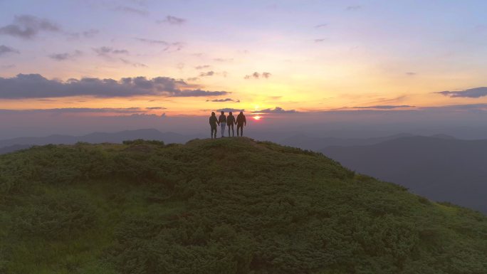 四个人站在山顶看日出