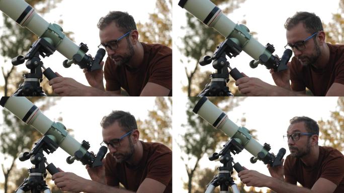 用望远镜观察户外天空的天文学家