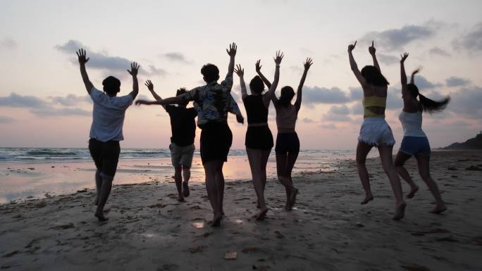 青少年团体夏天在海边海滩一起玩耍