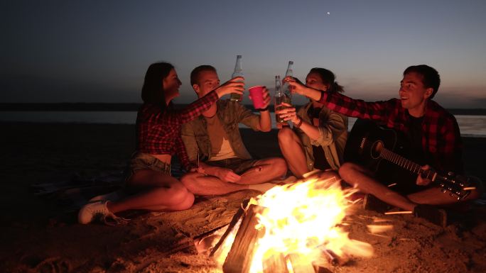 海滩篝火派对外国年轻人喝酒