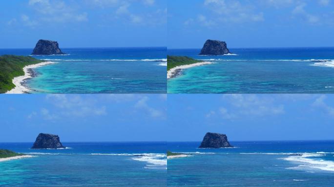 碧海蓝天热带鸟盘旋于岩石岛的航拍素材