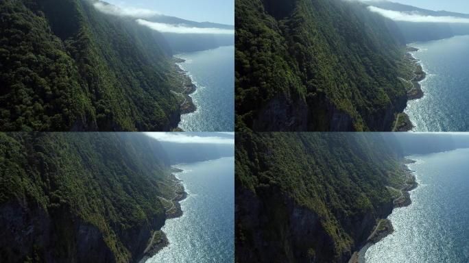 阳光下的海岸线航拍大海海水高山山峦