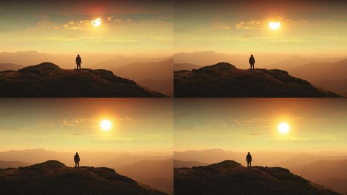 男人站在山顶上，对着美丽的日落