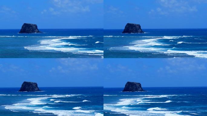 岩石岛前大浪滚滚热带鸟盘旋的航拍素材