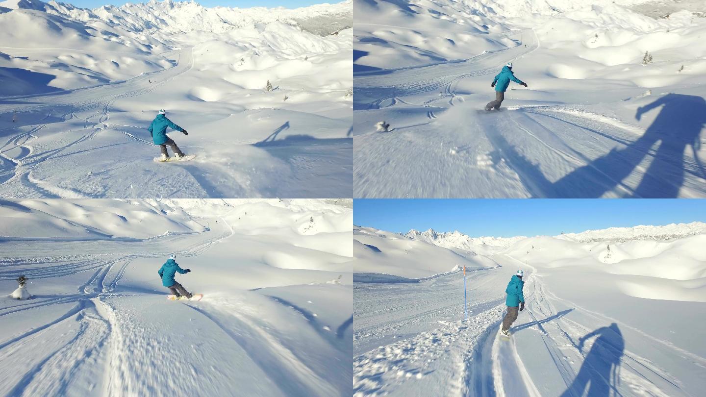 女性滑雪板运动员从雪坡上滑下。