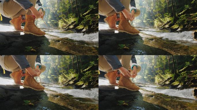 游客系鞋带。在山涧附近的森林里