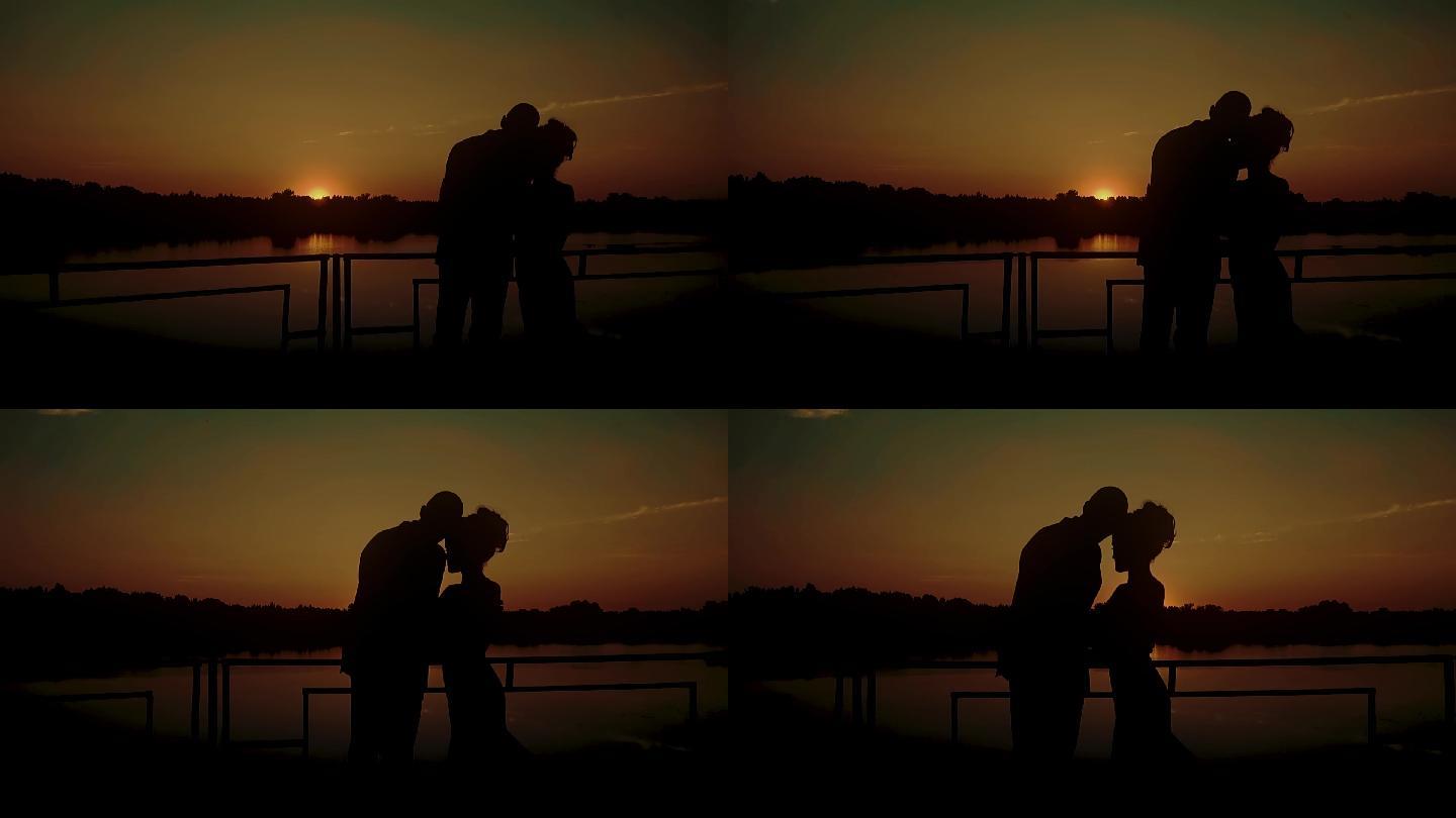 两个年轻人在河边夕阳下拥抱