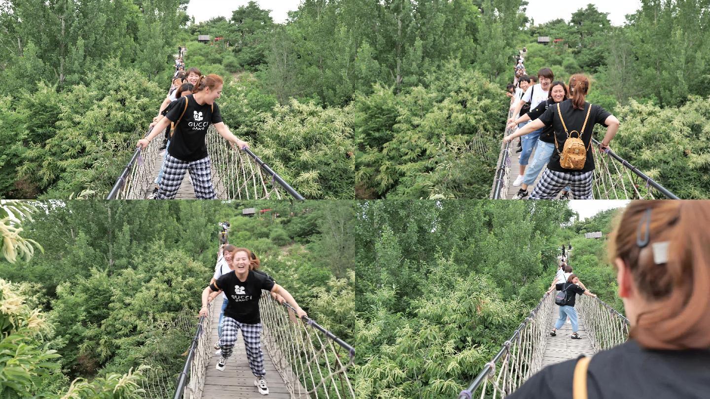 一群女生在吊桥上快乐玩耍的镜头