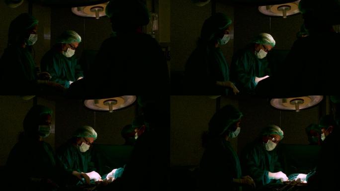 在手术室为病人做手术的外科医生团队。