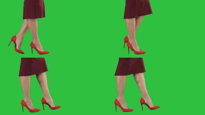 穿着红色高跟鞋的女人在绿色屏幕上行走