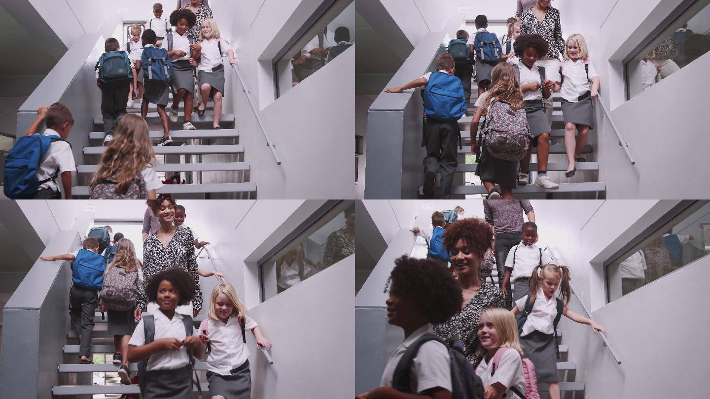 在繁忙的小学走廊里，老师和学生走下楼梯