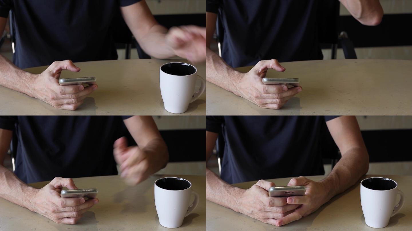 在桌上使用手机的男人喝着咖啡杯离去
