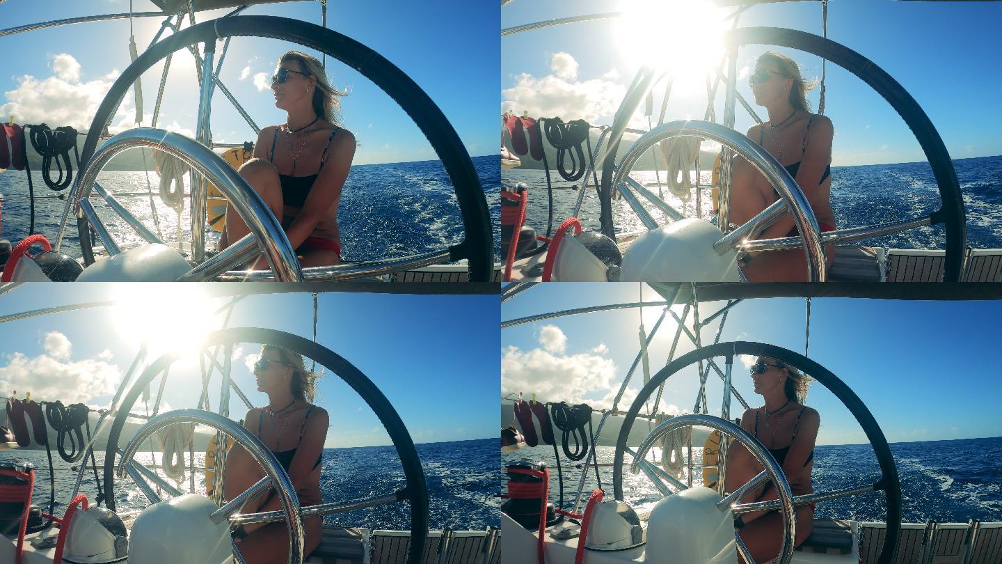 休闲的女人海钓帆船方向舵