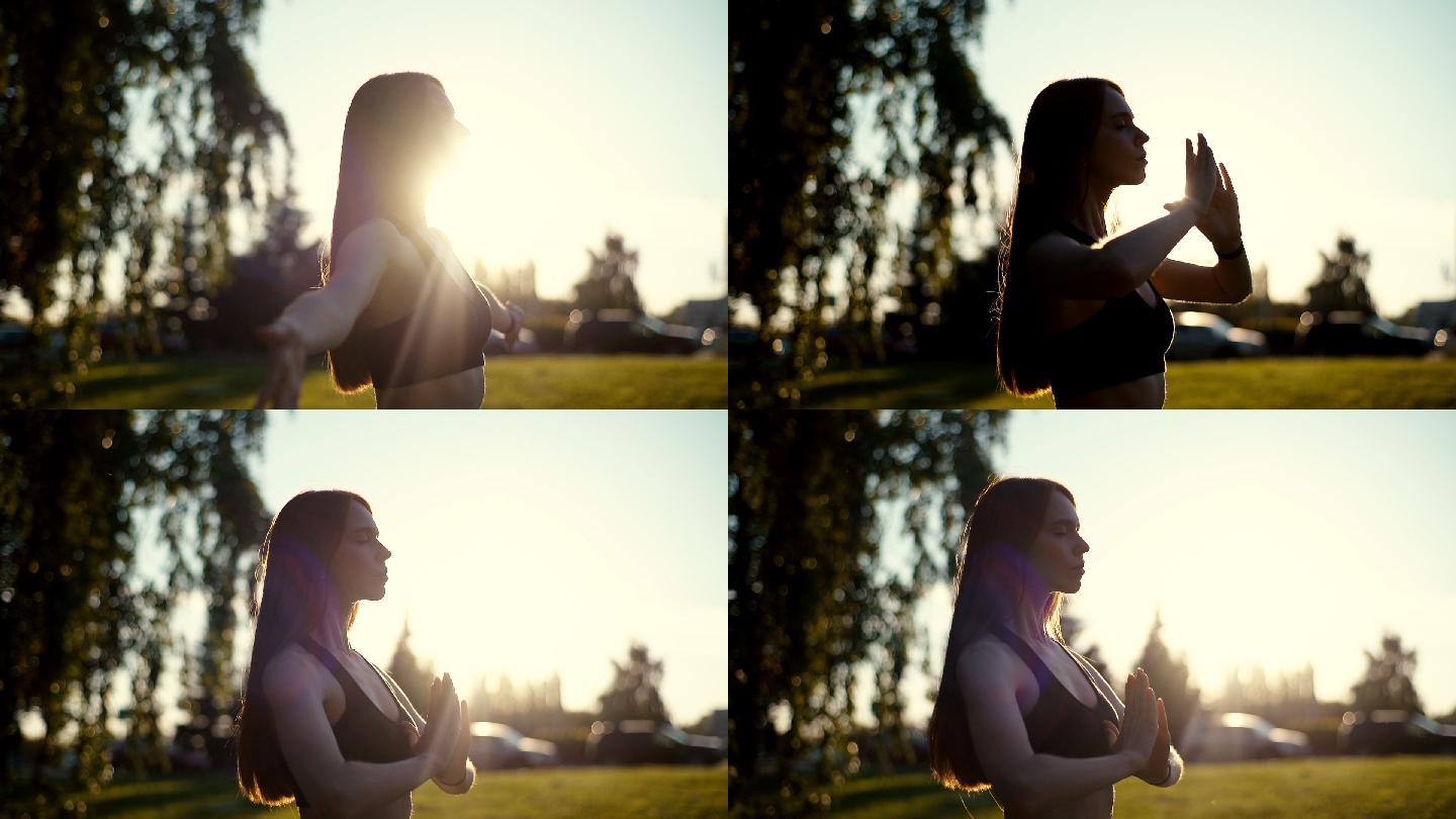 日落时分，一位年轻女子在公园里练瑜伽