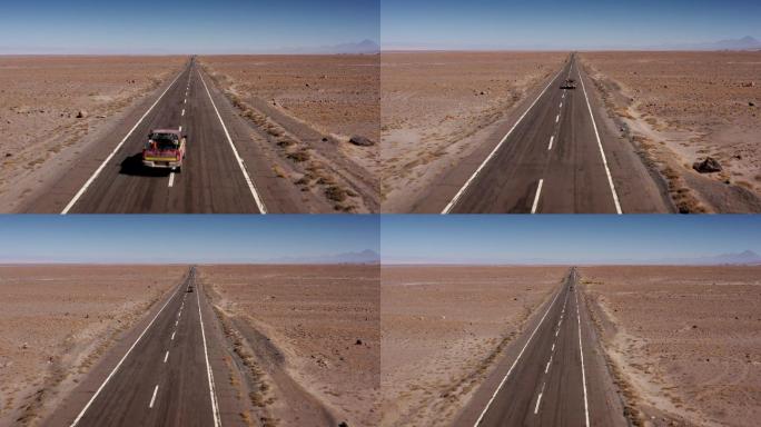 沙漠中一条公路上行驶的汽车