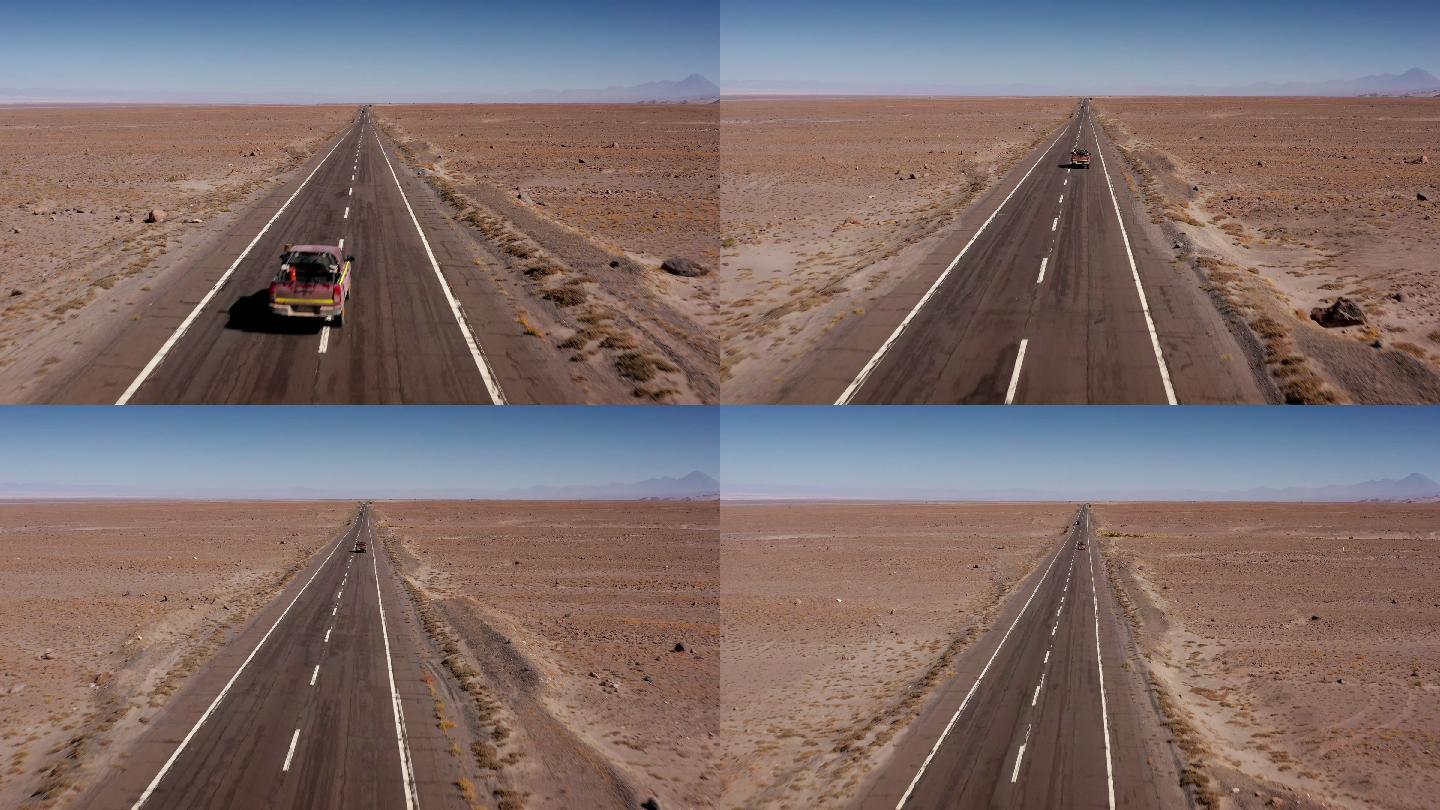 沙漠中一条公路上行驶的汽车