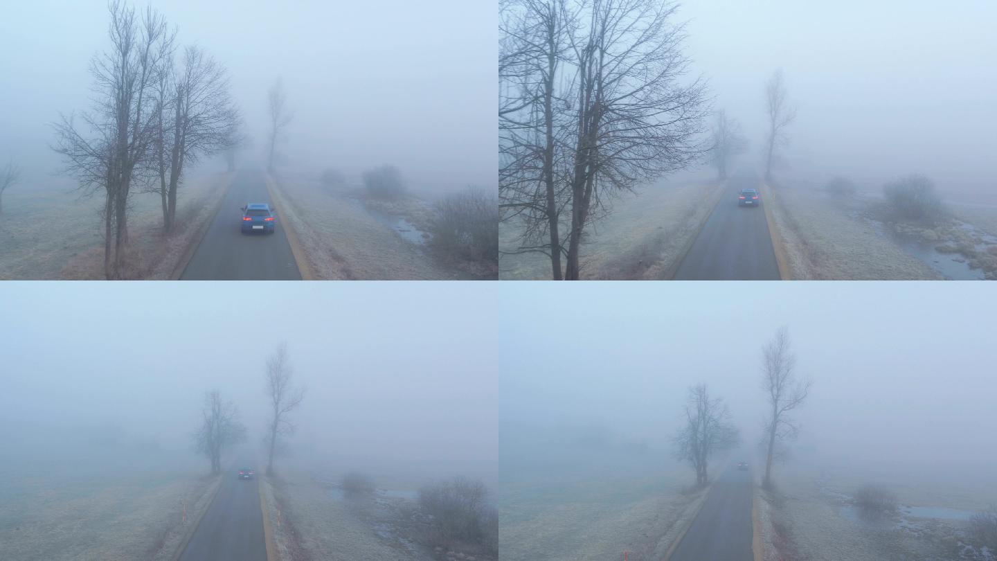 汽车行驶在雾蒙蒙的乡间小路上
