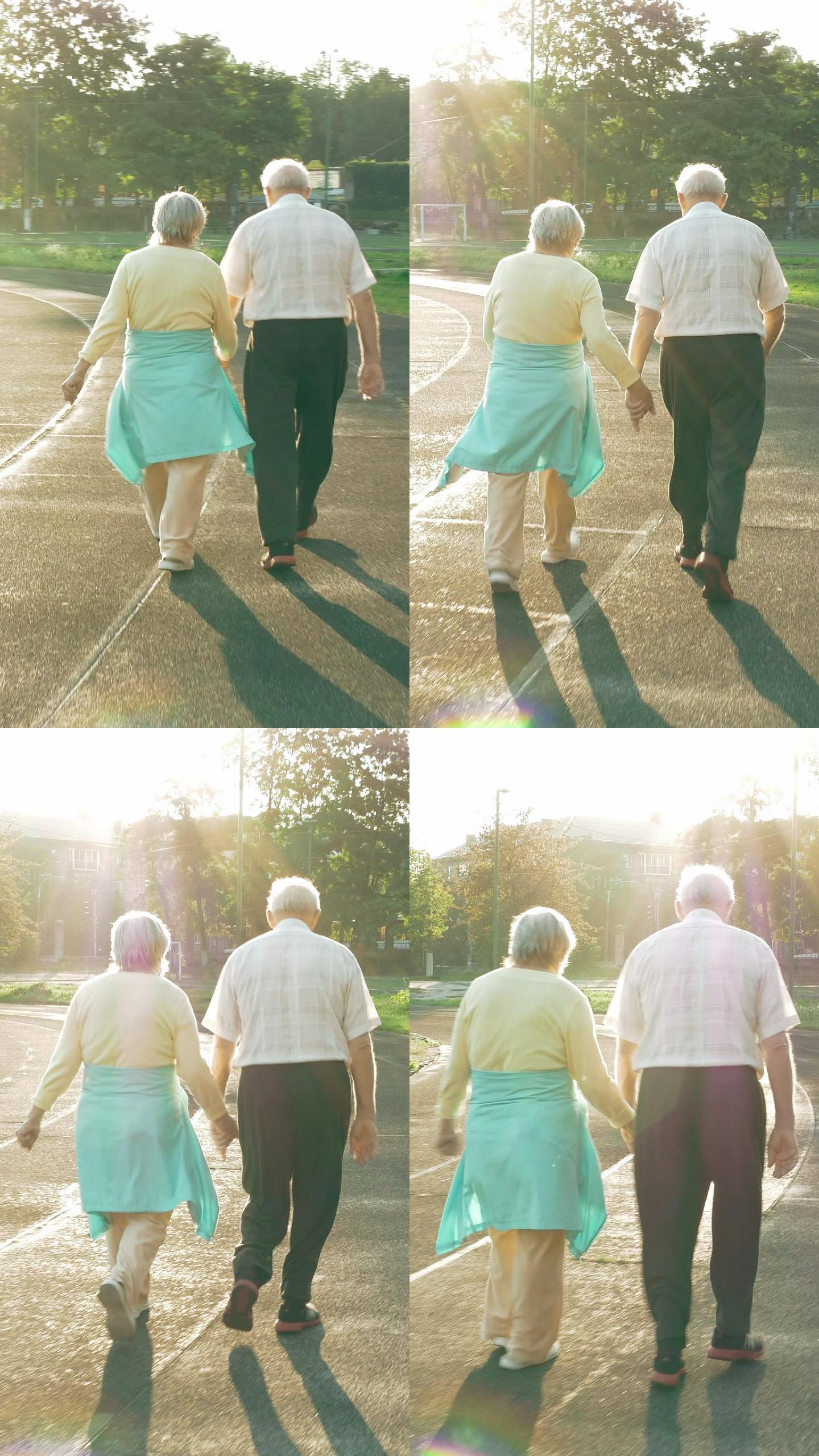 沿着跑道散步的老年夫妇